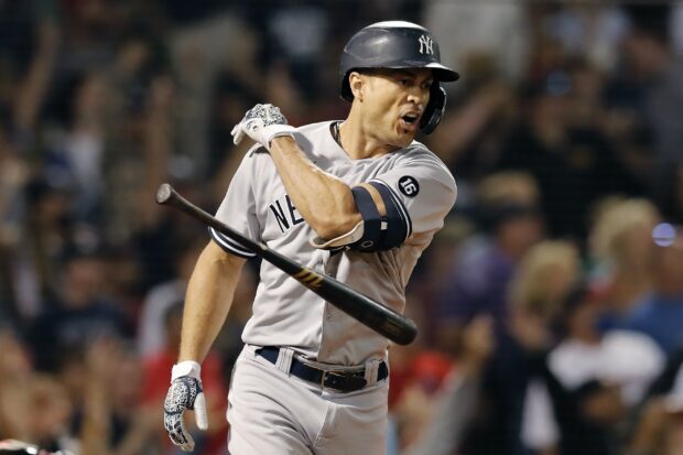 Giancarlo Stanton swinging the bat during a baseball game with intensity
