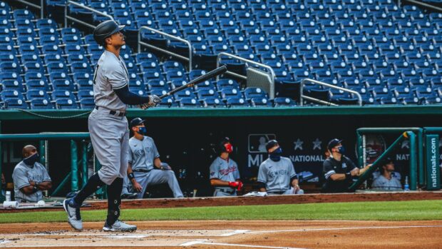 Giancarlo Stanton taking a swing at the baseball field during a game