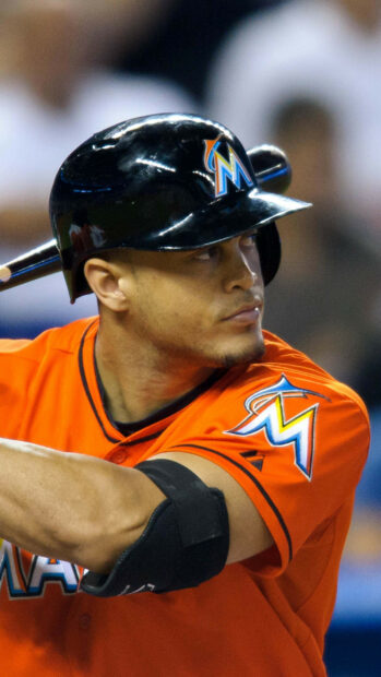 Giancarlo Stanton focused in Miami Marlins uniform preparing to bat in a baseball game