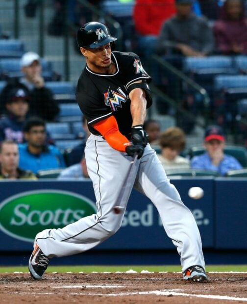 Giancarlo Stanton swinging the baseball bat in a Miami Marlins uniform