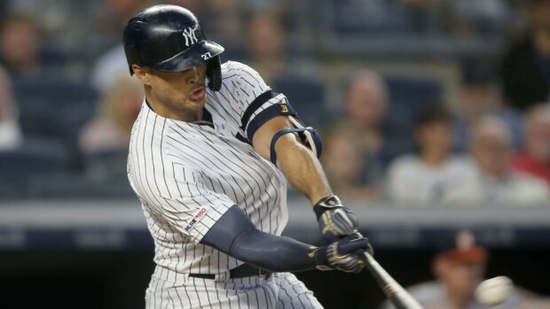 Giancarlo Stanton swinging the bat during a baseball game for the Yankees