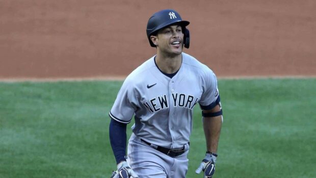 Giancarlo Stanton wearing New York uniform running on the baseball field