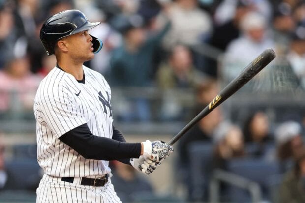 Giancarlo Stanton preparing to bat in a baseball game wearing a pinstripe uniform