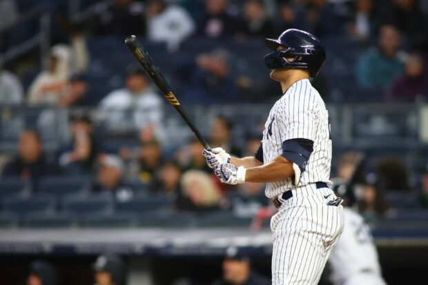 Giancarlo Stanton preparing to swing during a baseball game in a striped uniform
