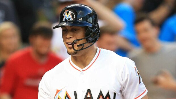 Giancarlo Stanton smiling in Miami baseball uniform during a game