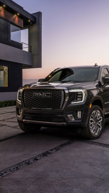 A black GMC SUV is parked on a driveway near a modern house at sunset, HD Mobile Wallpaper