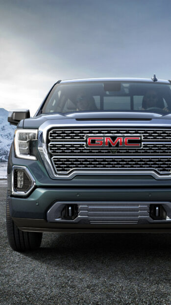A GMC truck is parked on a gravel road with mountains in the background, 4K Mobile Wallpaper