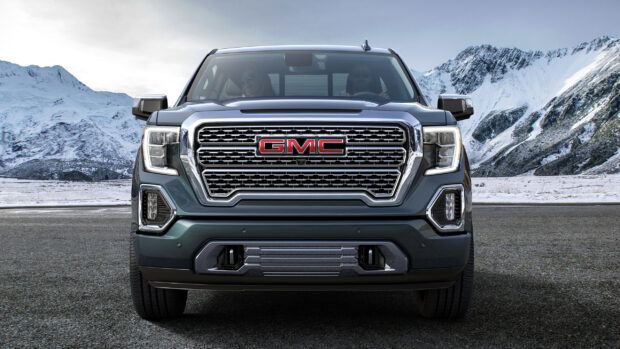 A GMC truck front shown with snowy mountains in the background, 2K Desktop Wallpaper
