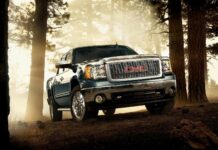 A GMC truck parked in a misty forest with sunlight filtering through the trees, HD Desktop Wallpaper