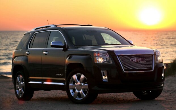 A black GMC vehicle parked near the ocean during sunset with lights on, HD Desktop Wallpaper