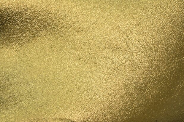 Close up of gold foil texture with metallic surface and fine details