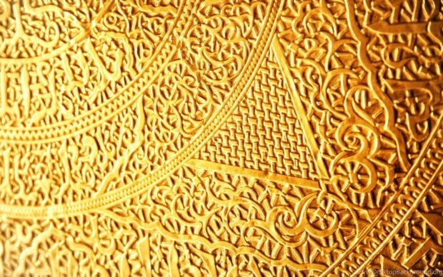 Detailed gold foil with intricate textured patterns and geometric designs