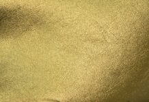 Close up of gold foil texture with metallic surface and fine details