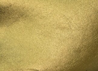 Close up of gold foil texture with metallic surface and fine details