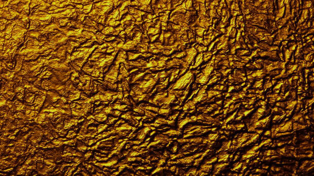 Crumpled gold foil texture showing detailed metallic patterns