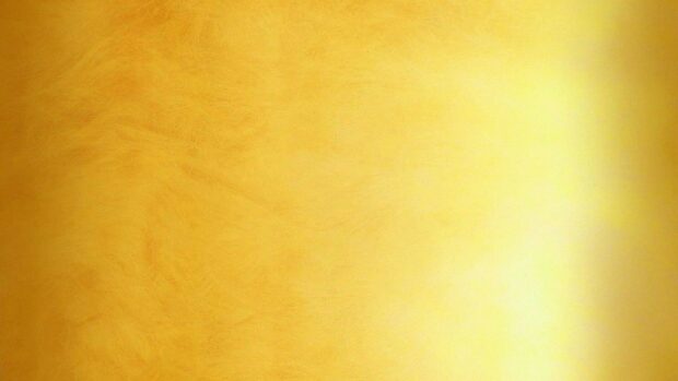 A textured gold foil surface with a smooth gradient effect on a vibrant gold foil background