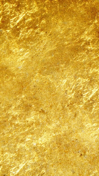 Shiny textured gold foil with detailed metallic patterns