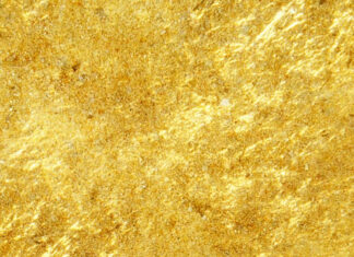 Shiny gold foil texture with reflective patterns and luxurious sparkling effect