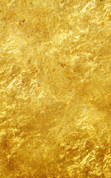 Shiny gold foil texture with reflective patterns and luxurious sparkling effect