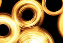 Circular golden light rings swirl against a dark background creating a glowing abstract pattern