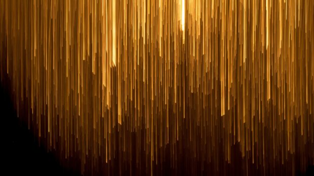 Vertical gold lights creating a glowing effect in a dark abstract design