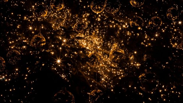 Golden lights sparkle in a dark background creating a festive and warm gold lights ambiance