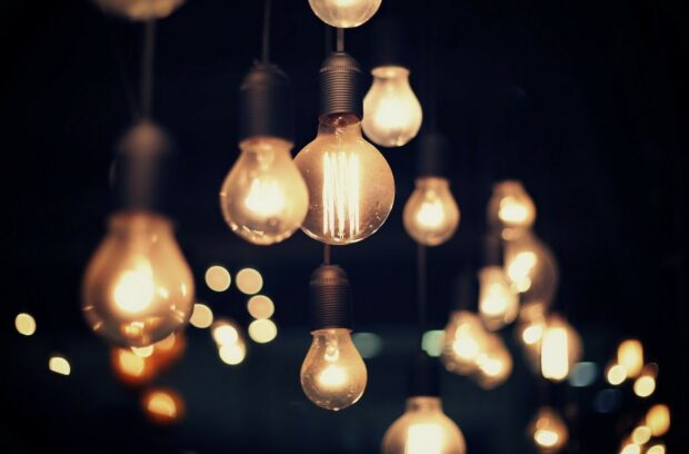 A collection of gold lights glowing softly in a dark setting creating a warm ambiance