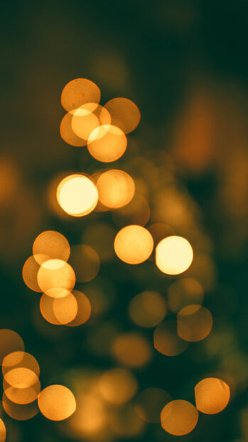 Soft glowing gold lights creating a warm bokeh effect in a dark setting