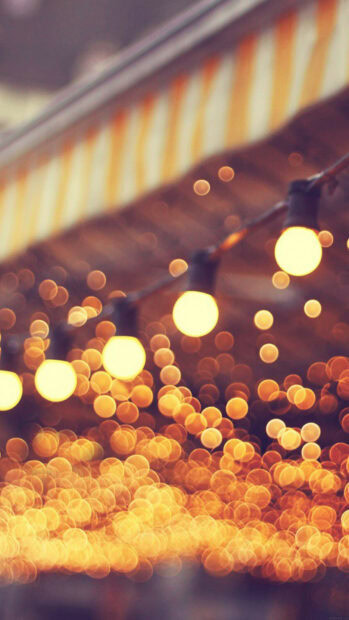 Warm gold lights glowing softly in a festive setting with string lights hanging above