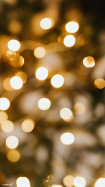 Soft gold lights create a warm glowing effect in a blurred abstract scene