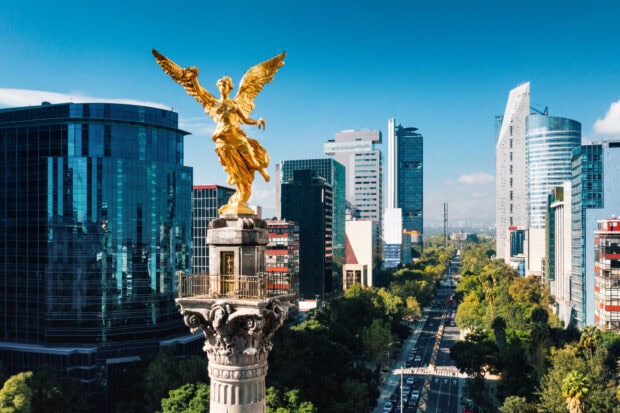 The golden Angel statue overlooks Mexico City with modern skyscrapers in the background, HD Desktop Wallpaper