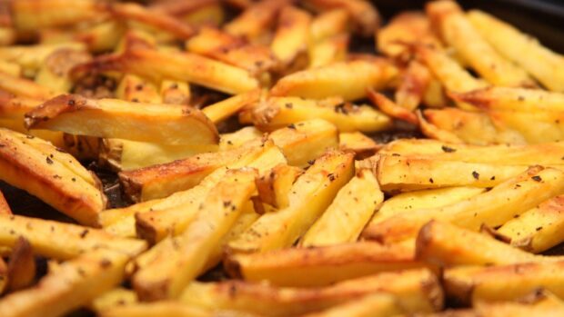 A close up of golden French fries freshly cooked with pepper seasoning, HD Desktop Wallpaper