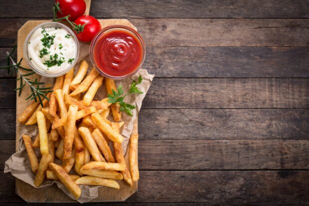 Golden french fries are served with ketchup and mayonnaise on a wooden board, HD Desktop Wallpaper