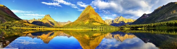 The golden mountain peaks are perfectly reflected in the clear lake in Glacier National Park, 4K Desktop Wallpaper