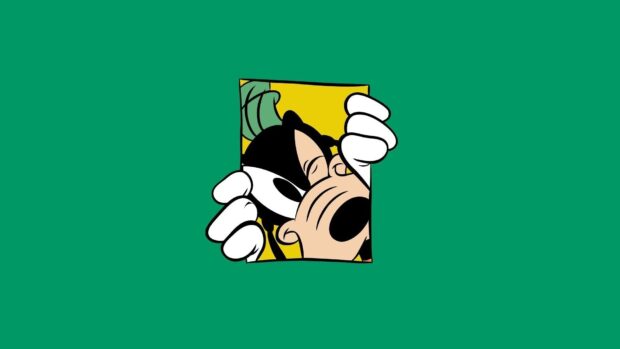 Goofy face peeking through a small yellow square on a green background with a playful expression