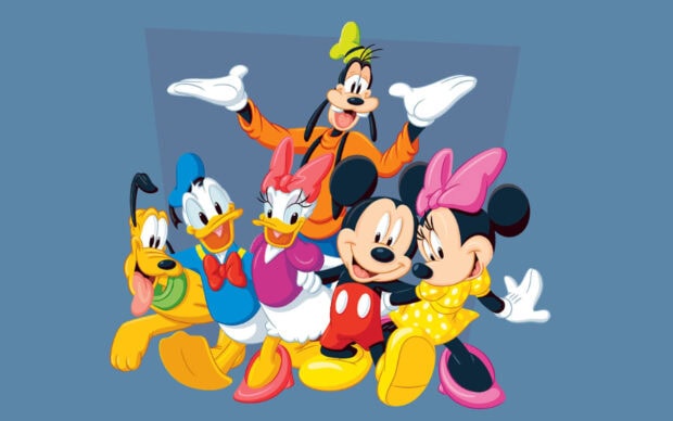 Goofy standing happily with classic Disney characters in colorful outfits