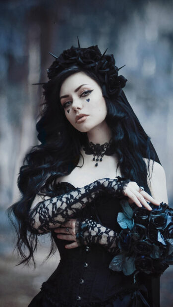 Gothic woman with lace gloves holding black roses in dark elegant style