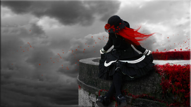 Gothic style woman with red hair sitting by stone well under cloudy sky