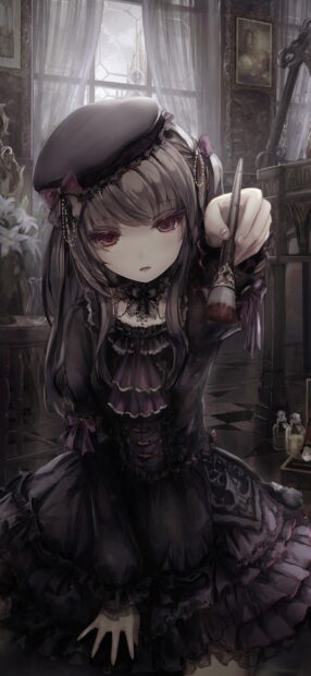 Goth style girl holding a brush in a dark vintage room with lace dress and hat