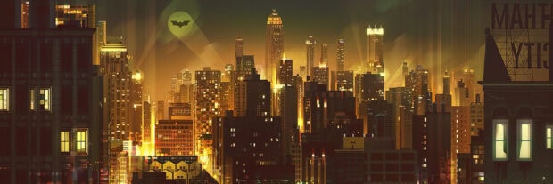 Gotham skyline with illuminated buildings and bat signal shining in the night sky