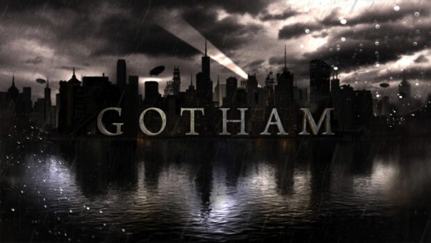 Gotham skyline with dark rainy weather and city lights reflecting on water