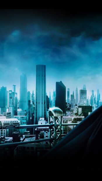 Gotham skyline viewed from a high rooftop with tall buildings under a cloudy sky