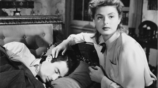 A woman comforts a man resting on a couch in a Gregory Peck scene, 2K Desktop Wallpaper