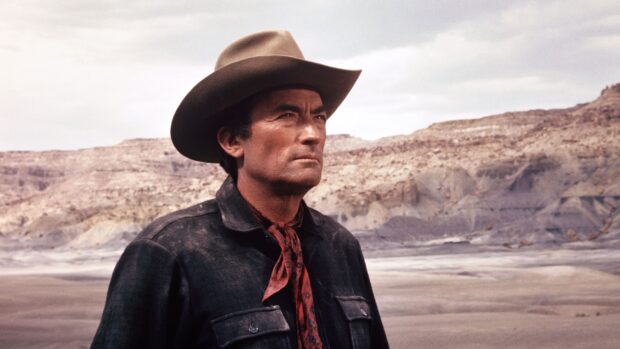 Gregory Peck is seen wearing a cowboy hat and scarf in a desert landscape, 4K Desktop Wallpaper