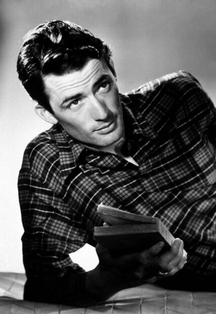 Gregory Peck is reading a book while lying down in a plaid shirt, HD Desktop Wallpaper