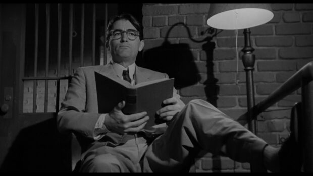Gregory Peck is sitting and reading a book in a black and white setting, HD Desktop Wallpaper