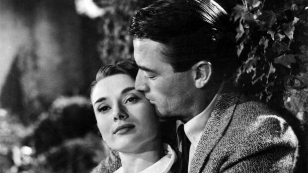 Gregory Peck shows a tender moment with a woman in a black and white setting, HD Desktop Wallpaper