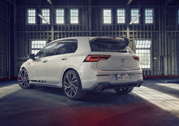 White Gti hatchback parked inside an industrial warehouse with large windows