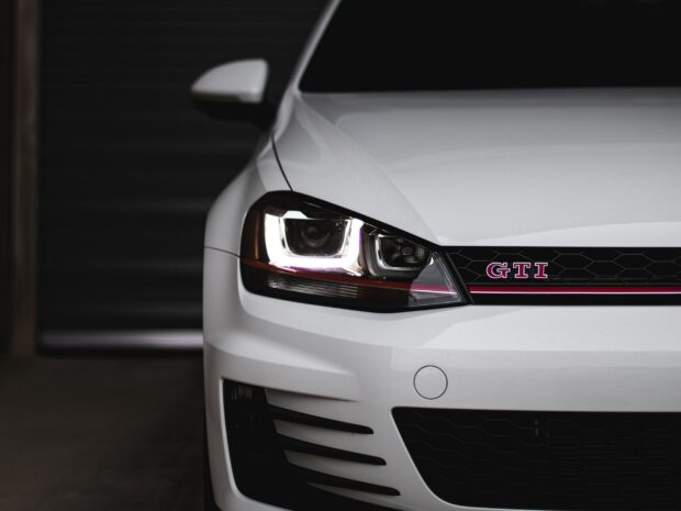 Close up of car front with GTI emblem and headlight in white color