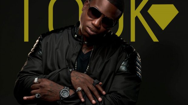 Gucci Mane wearing sunglasses and black jacket with jewelry on his hands